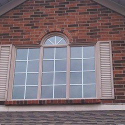 Coloured curved window with white grills