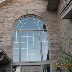 Curved window above steel door