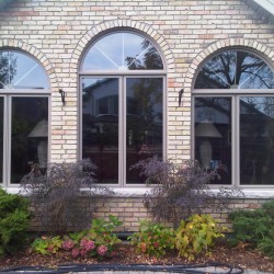 Double casements with curved windows above