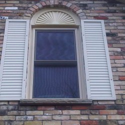 Double hung window with curved fan above