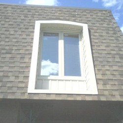 Window installed in dormer and siding put around the outside