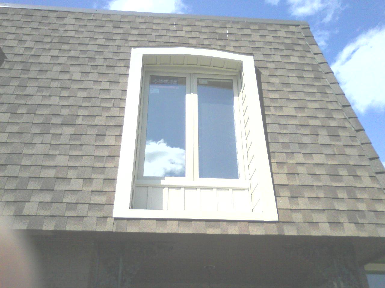 Window installed in dormer and siding put around the outside